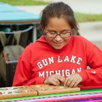 Girl playing mancala at the event